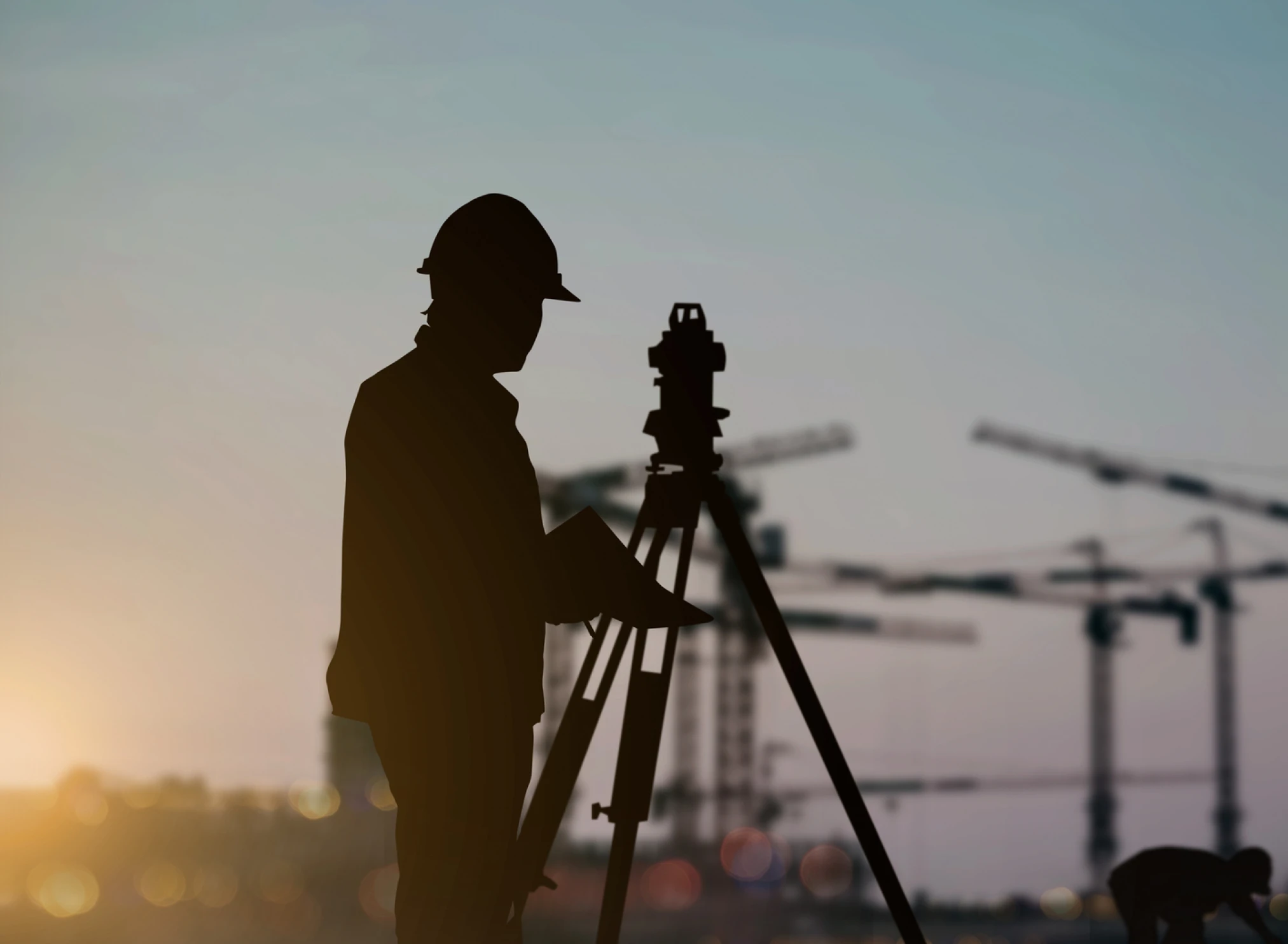Surveyor silhouette at construction site